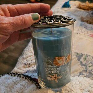 Yankee Candle with enhancer for the lid.  The Lid can be reused on other candles